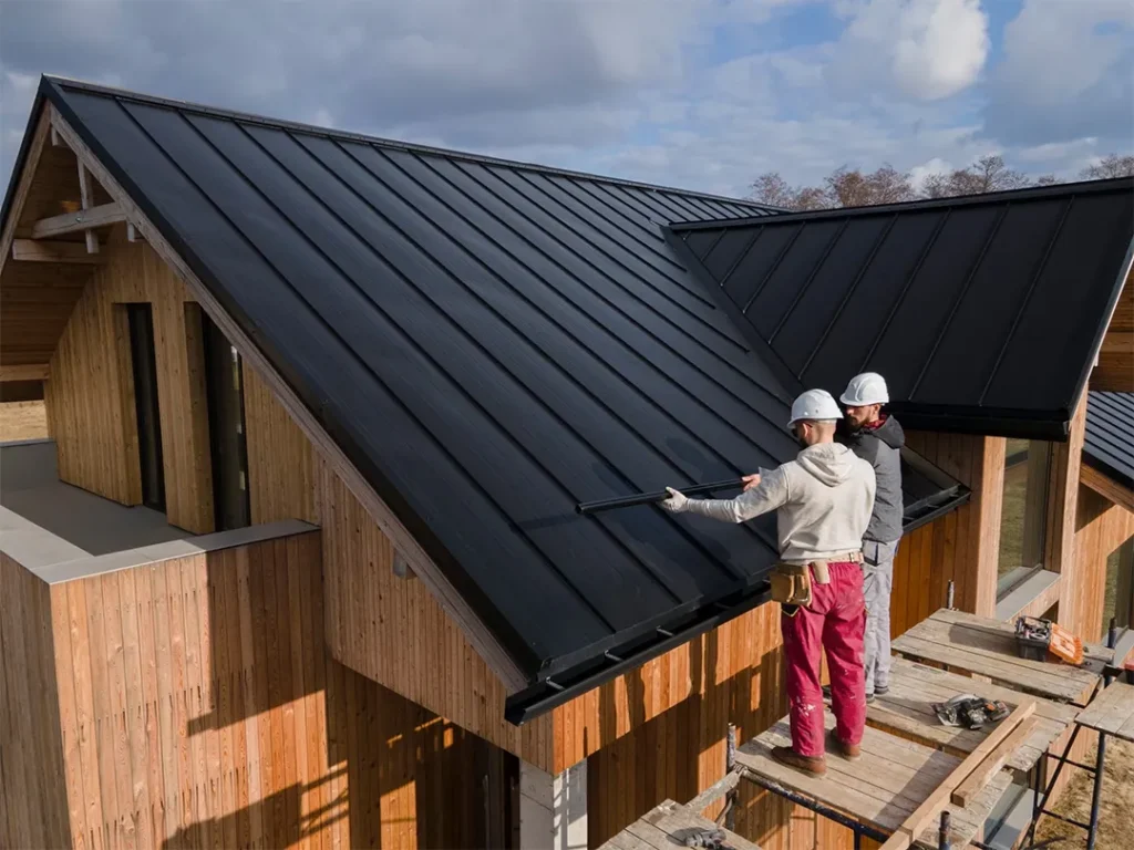 Two builders diligently working on a rooftop.